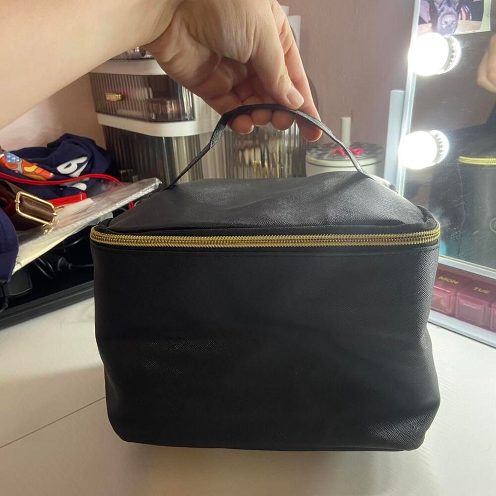 Black toiletry bag with gold zipper